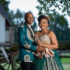 a man and woman standing next to each other in front of a horse drawn carriage