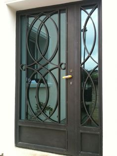 an iron door with glass panels on the outside