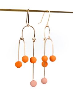 Clay Earrings - Perfectly balanced and exuding kinetic energy, these modern earrings are truly art in movement. An asymmetric, gold-filled wire creates a mesmerizing illusion, while the colorful, porcelain dancing dots add a playful touch. Gold-filled ear wires. Porcelain Earrings, Kinetic Energy, Asymmetrical Earrings, Artful Home, Modern Earrings, Creative Inspiration, Ear Wires, Clay Earrings, Earrings Handmade