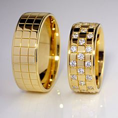 two gold wedding rings with diamonds on them