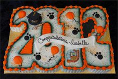 a decorated cake with the number twenty four in frosting and paw prints on it