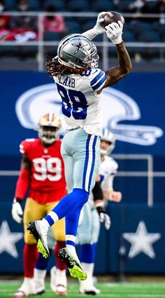 a football player jumping up into the air