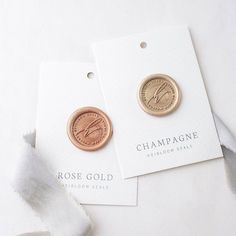 two small gold and silver coins on top of white paper