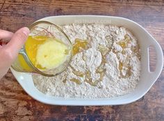 someone is mixing ingredients in a bowl on the table