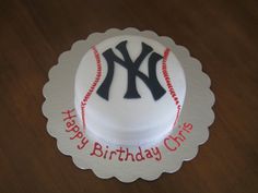 a birthday cake for a new york yankees baseball player on a wooden table with the words happy birthday christ