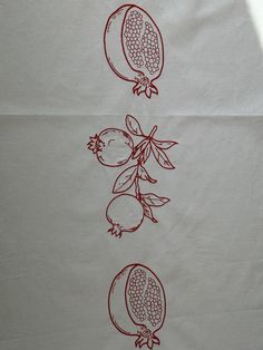 three pomegranates drawn on white paper with red ink in the middle