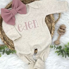 A personalized gender-neutral baby romper outfit is a simple and classic choice for your baby's coming home outfit.  The romper is made of soft, breathable fabric in a neutral oatmeal-beige color and is a gentle on your baby's skin. The baby footie features mitten cuffs for the hands and feet and snaps along the legs for easy diaper changes. Complete the outfit with a matching hat.  Remember, the most important thing is that your baby is comfortable and feels cozy in their coming home outfit. A personalized gender-neutral romper can be a cute and meaningful choice, and it's sure to make for some adorable photos to cherish for years to come! Choose a romper that is appropriate for your baby's size and age. Newborn size or 0-3 months size is typically suitable for a coming home outfit, but b Personalized Cotton Onesie For Loungewear, Baby Romper Outfit, Girl Coming Home Outfit, Baby Coming Home Outfit, Personalized Baby Shower Gifts, Girls Coming Home Outfit, Going Home Outfit, Matching Hat, Personalized Baby Shower