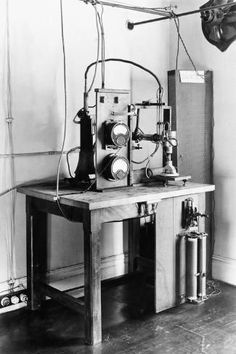 a black and white photo of an old fashioned machine on a table in a room