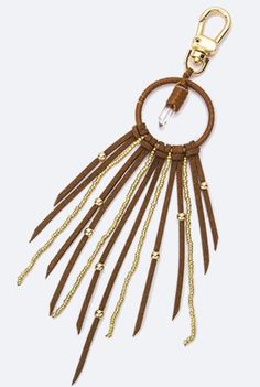 a brown leather keychain with gold chains hanging from it's center loop