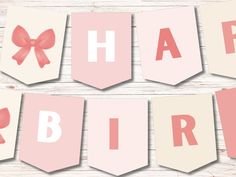 pink and white happy birthday banner with red bow on wood planked wall behind it