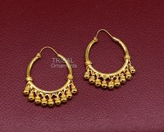 Amazing gold polished over pure 925 sterling silver amazing stylish antique design hoops earrings bali, fabulous hanging bells, awesome gifting tribal jewelry form Rajasthan india. Metal-925 Sterling silver. Type- stud earrings Stamp-925. Weight-12.040 grams length-4.4 centimeter with bells. Width-3.0 centimeter. Finish-Gold polished over 925 sterling silver bali. Makes excellent gifting and collectible pieces. Festive Chandbali Jewelry With Bells, Brass Hoop Earrings With Latkans For Festivals, Brass Temple Jewelry Hoop Earrings For Festivals, Traditional Gold Chandbalis With Dangling Beads, Festival Hoop Earrings With Latkans, Traditional Brass Earrings With Dangling Beads, Intricate Dangle Hoop Earrings For Festivals, Festive Hoop Dangle Earrings With Latkans, Traditional Dangle Hoop Earrings For Festivals