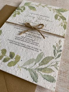 the wedding card is wrapped in brown paper