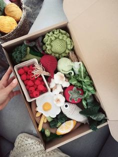 a box filled with crocheted fruits and vegetables