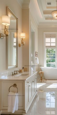 an elegant bathroom with white marble flooring and gold accents on the walls, along with large windows