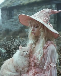 a woman in a pink dress and hat holding a white cat