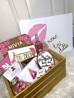 a wooden box filled with assorted items on top of a white furnishing