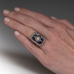 This fantastic circa Victorian era ring features a sterling silver and 18K yellow gold octagonal shaped gallery. The center of the gallery is topped with a diamond accented sterling silver star setting bordered with blue enamel. The star shaped setting is centered with one (1) bead set, old European cut diamond and is bordered with fourteen (15) old mine/rose cut diamonds bead set into the points of the star. The gallery is framed with thirty (30) old mine/singe cut diamonds bead set into sterli Yellow Gold Enamel Jewelry With Rose Cut Diamonds, Fine Jewelry Black Enamel Diamond Ring, Luxury Enamel Ring With Diamond Accents For Gift, Luxury Enamel Ring With Diamond Accents As Gift, Art Deco Enamel Ring Jewelry, Art Deco Enamel Jewelry Ring, Art Deco Enamel Jewelry For Anniversary, Collectible Hallmarked Enamel Ring In Fine Jewelry Style, Fine Jewelry Enamel Ring With Rose Cut Diamonds