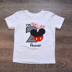 a t - shirt with the number two on it and a mickey mouse design is shown