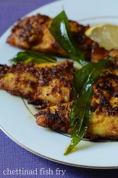 grilled fish with herbs and lemon on a plate