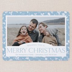 a blue christmas card with the words wishing you a merry christmas and an image of two people