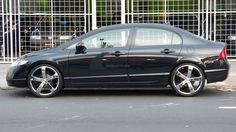 a black car parked in front of a building