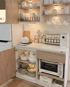 a kitchen with white appliances and wooden shelves