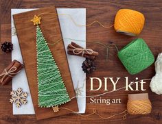 the diy kit includes yarn, twine and christmas tree decorations on wooden boards