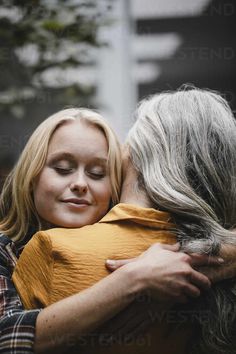 two women embracing each other in front of a building by jovan for stocks on artfire