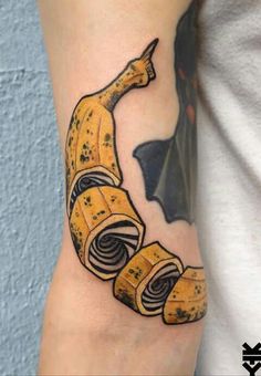 a banana tattoo on the arm with some bananas wrapped around it's peels