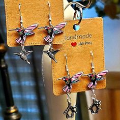 2 Handmade Enamel Hummingbird Charm Earrings. There Are Silver Birdhouse Charms I Added To The Bottom On One Pair & Silver Hummingbird Charms On The Other Pair. Very Pretty Dangle Earrings. The Enamel Finish And Colors Are Beautiful. These Have Silver Hook Earrings With Rubber Backings. When Choosing Which One Look At The Sizes And Choose Between Birdhouse Charm Or Hummingbird Charm. Brand New And Packaged. Pretty Dangle Earrings, Pretty Earrings Dangle, Hummingbird Earrings, Birdhouse, Hook Earrings, Charm Earrings, Pink Purple, Dangle Earrings, Handmade Jewelry