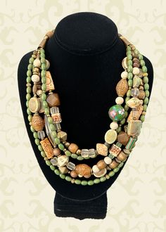 One-of-a-kind multi-strand statement necklace. Handcrafted in Scottsdale, Arizona. Beads: 5 strands of Carved Bone and Jade, Ceramic, Vintage Glass, Wood and Brass. Dimensions: approximately 26" + 3" extender. Make a Statement with this interesting mixture of nature and craftsmanship! Free Shipping Refund Policy Green Multi-strand Wooden Beads Jewelry, Unique Multi-strand Polished Beads, Costume Jewelry With Large Beads And Multi-strand, Unique Multi-strand Large Beads Jewelry, Unique Multi-strand Jewelry With Large Beads, Unique Multi-strand Wooden Beaded Necklaces, Multi-strand Wooden Beads For Jewelry Making, Multi-strand Beaded Necklaces, Wooden Multi-strand Beads For Jewelry Making