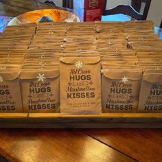 many bags of hugs are lined up on a table with doughnuts in the background