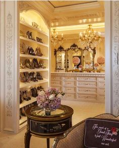 a room filled with lots of shoes and chandeliers