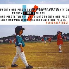 a young boy standing on top of a baseball field