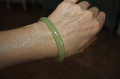 Gorgeous, elegant and classy Natural Light Green Jade bracelet bangle. Here is a link to a youtube video that can help you determine the best size for your wrist. https://www.youtube.com/watch?v=QAEmQQCRzMc It is believed in Chinese tradition that Green Jade symbolized the five virtues of humanity, which are courage, modesty, justice, compassion, and wisdom. It's mainly considered as a symbol of serenity, tranquility, and purity. It's a stone that's believed to bring in good luck, friendship, pe Jade Bracelet Chinese, Green Jade Bracelet, Hamsa Bracelet, Carnelian Bracelet, Hamsa Charm, Brown Leather Bracelet, Chinese Jade, Black Peach, Jade Bangle