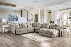 a living room filled with furniture on top of a hard wood floor