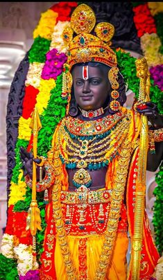 an idol is displayed in front of flowers