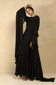 Colour : BlackFabric : Chiffon & Satin LiningDetails : Fitted, Cape Sleeve Floor Length Gown, Back Zip & Hook for Closure.Length : 59 inchesTHE MEASUREMENTS ARE IN INCHES Shoulder Bust Waist Low Waist Hips Armhole Extra Small 14 34 27 29 38 14 Small 14.5 36 29 31 40 15.5 Medium 15 38 31 33 42 16.5 Large 15.5 40 33 35 44 17.5 XL 16 42 35 37 46 18.5 XXL 17 44 37 39 48 19.5 Care• Dry Clean Only• Do Not Bleach• Steam Iron OnlyThis item is Made-To-Order. Please allow up to 21 working days for us to m Black Georgette Dress With Cape Sleeves, Black Cape Sleeve Festive Dresses, Elegant Black Georgette Maxi Dress, Evening Black Georgette Maxi Dress, Black Georgette Maxi Dress For Evening, Flowy Georgette Evening Gown, Black Festive Evening Gown, Fitted Black Georgette Maxi Dress, Black Fitted Georgette Maxi Dress