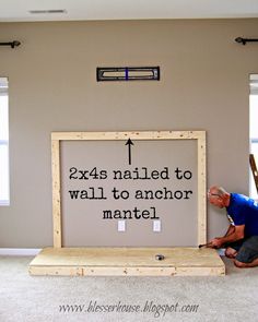 a man kneeling on the floor next to a sign that says, x4s nailed to wall to another mantel