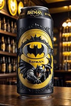 a batman beer can sitting on top of a wooden table in front of a bar