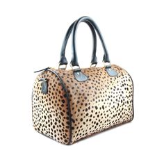 Leather leopard calf hair duffle bag with leather carry handles and detachable shoulder strap, main zipper compartment with genuine suede lined interior, and four inside pockets. PRODUCT INFO: Size: 8.5" H x 12.5" W x 8" D inchesTop Strap Handle Drop: 6.5" inches Strap Length: 49" inches Strap Handle Drop: 19" inches Material: Genuine calf hair leather. Fully lined with soft suede. Features: YKK Zipper; Removable leather shoulder strap; Interior zipper pocket and cell phone holder. Handmade with Leopard Print Bag, Leopard Outfits, Clare Vivier, Animal Bag, Leather Duffle Bag, Barrel Bag, Leather Duffle, Pretty Stuff, Wild Things