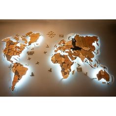 a world map made out of wooden pieces with lights on it and birds flying around