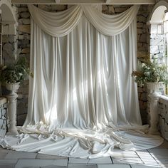 a room with stone walls and white drapes