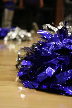 purple and silver tinsel sitting on top of a wooden table