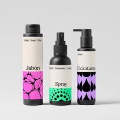 three different types of hair care products on a white surface with black and pink designs