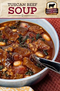 a close up of a bowl of stew with meat and spinach on the side