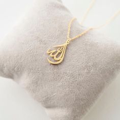 This necklace is a piece of our new collection of Allah necklace made from sterling silver and 14k gold. The collection includes different designs that suit all tastes Kufi/calligraphy, heart/rectangle/triangle shapes, tiny/big sizes. Here is the link for the full collection: https://etsy.me/2Swd0lPAll the designs can be made as necklace, bracelet, and earrings. If you also want a complete set that includes a necklace, a bracelet and earrings please get in touch with us. We accept custom orders! Yellow Gold Teardrop Pendant Necklace With Charms, Yellow Gold Teardrop Charm Necklace, Yellow Gold Teardrop Necklace With Charms, Elegant Teardrop Pendant Necklace With Charms, Teardrop Jewelry Charms For Gifts, Teardrop Charm Jewelry Gift, Teardrop Charms Jewelry For Gifts, Teardrop Charms Jewelry Gift, Gift Teardrop Jewelry With Charms