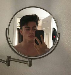 a young man is taking a selfie in the mirror