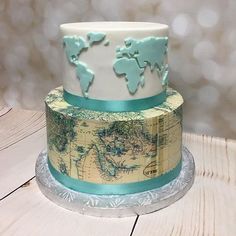 a three tiered cake with a world map on it