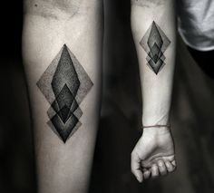 two people with matching tattoos on their legs, one is holding the other's hand